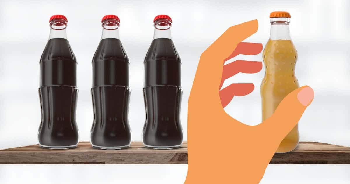 Person reaching past popular soda to grab less popular soda with cool packaging